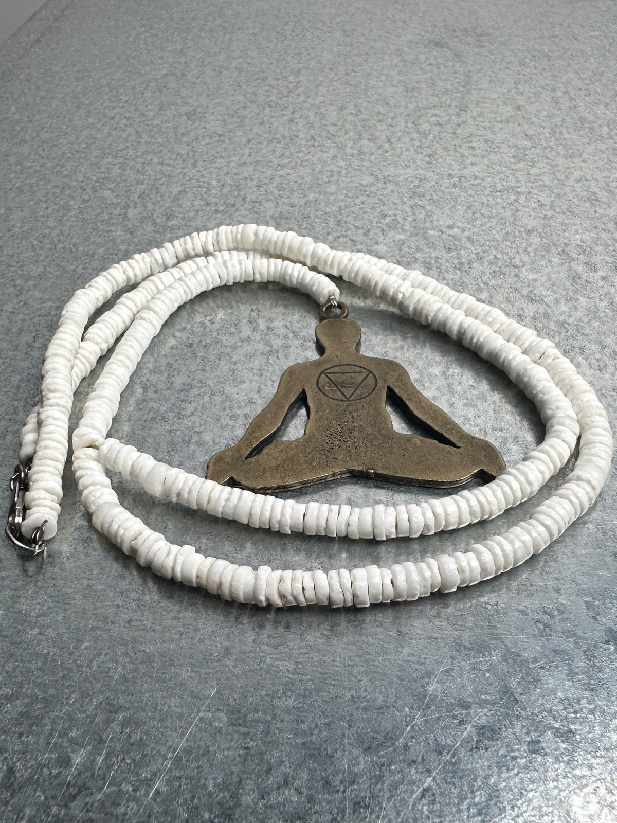 The necklace, shell strand and lotus figure pendant