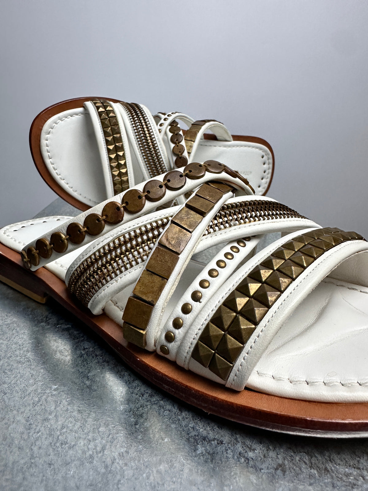 Brass studwork and zipper-tooth bands close