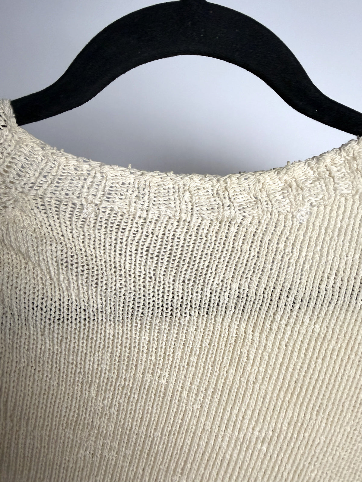 Clear fasteners at the back neck, where the tags were attached