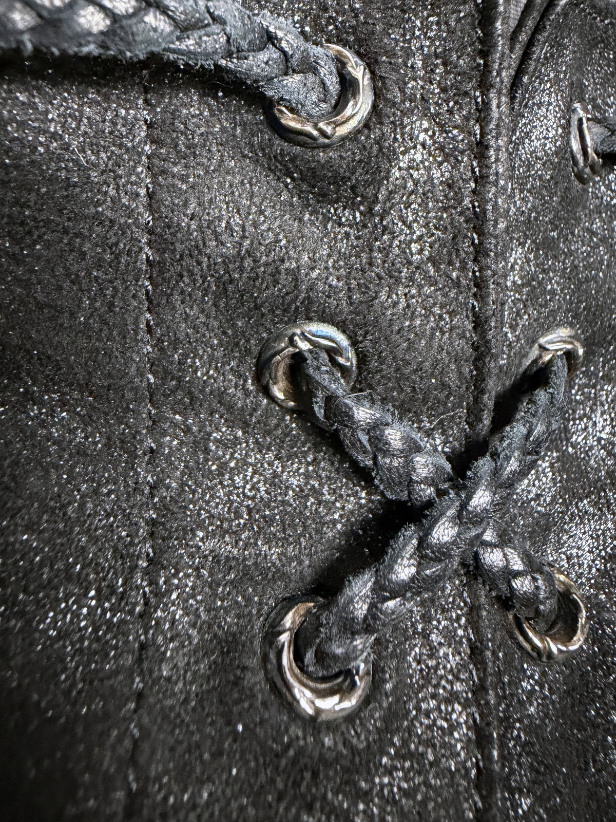 Fly detail, cast scroll grommets