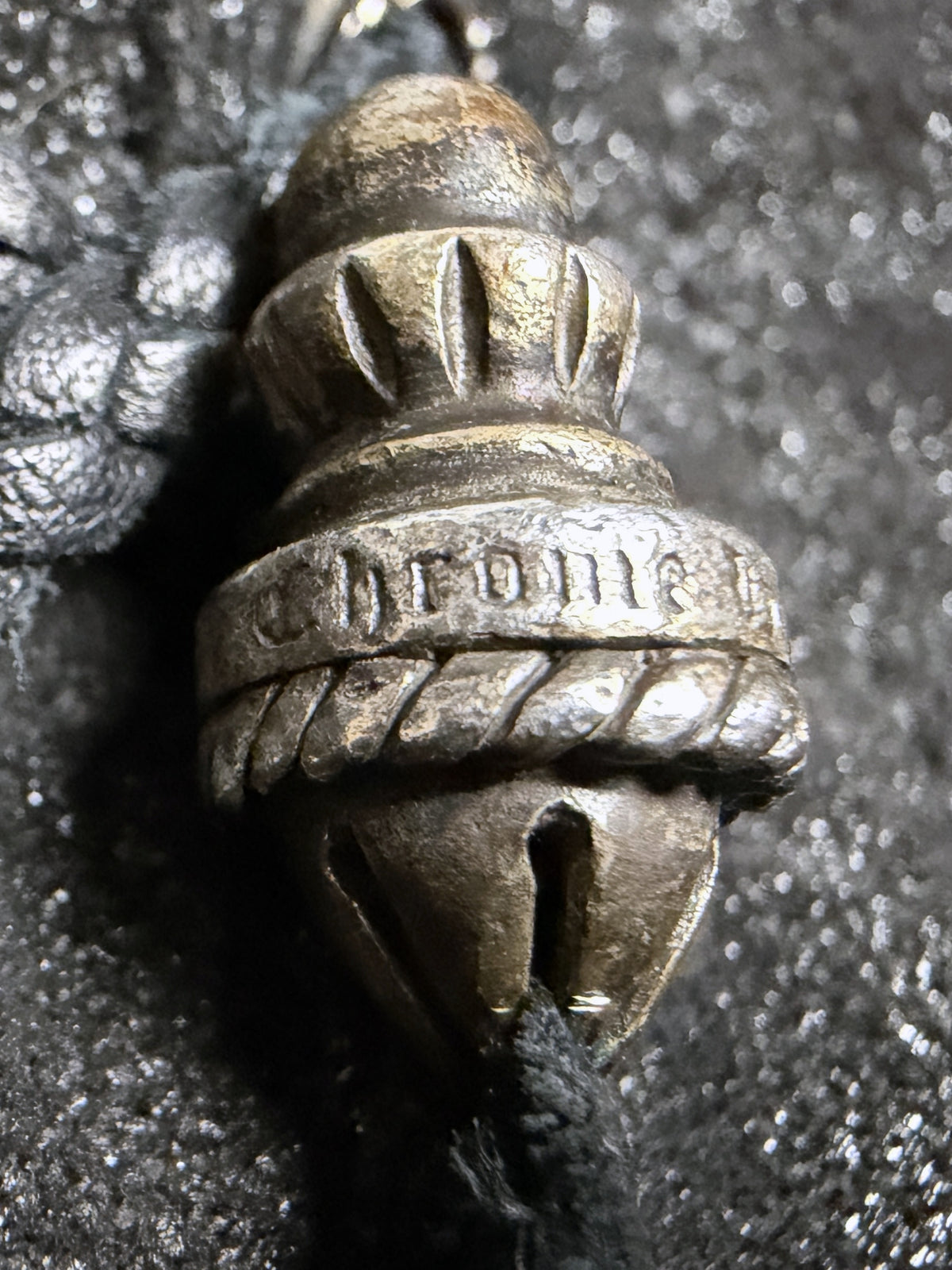 Acorn cord tip engraved Chrome Hearts, macro