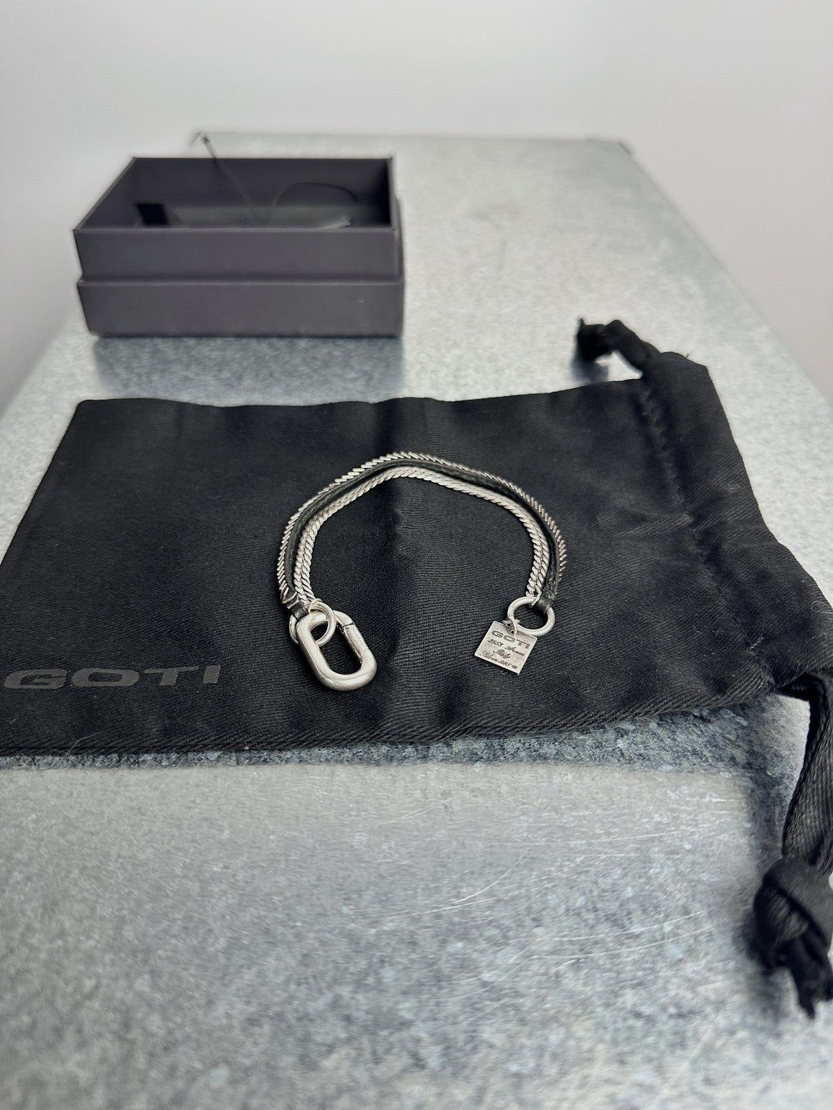 On the pouch, clasp and tag