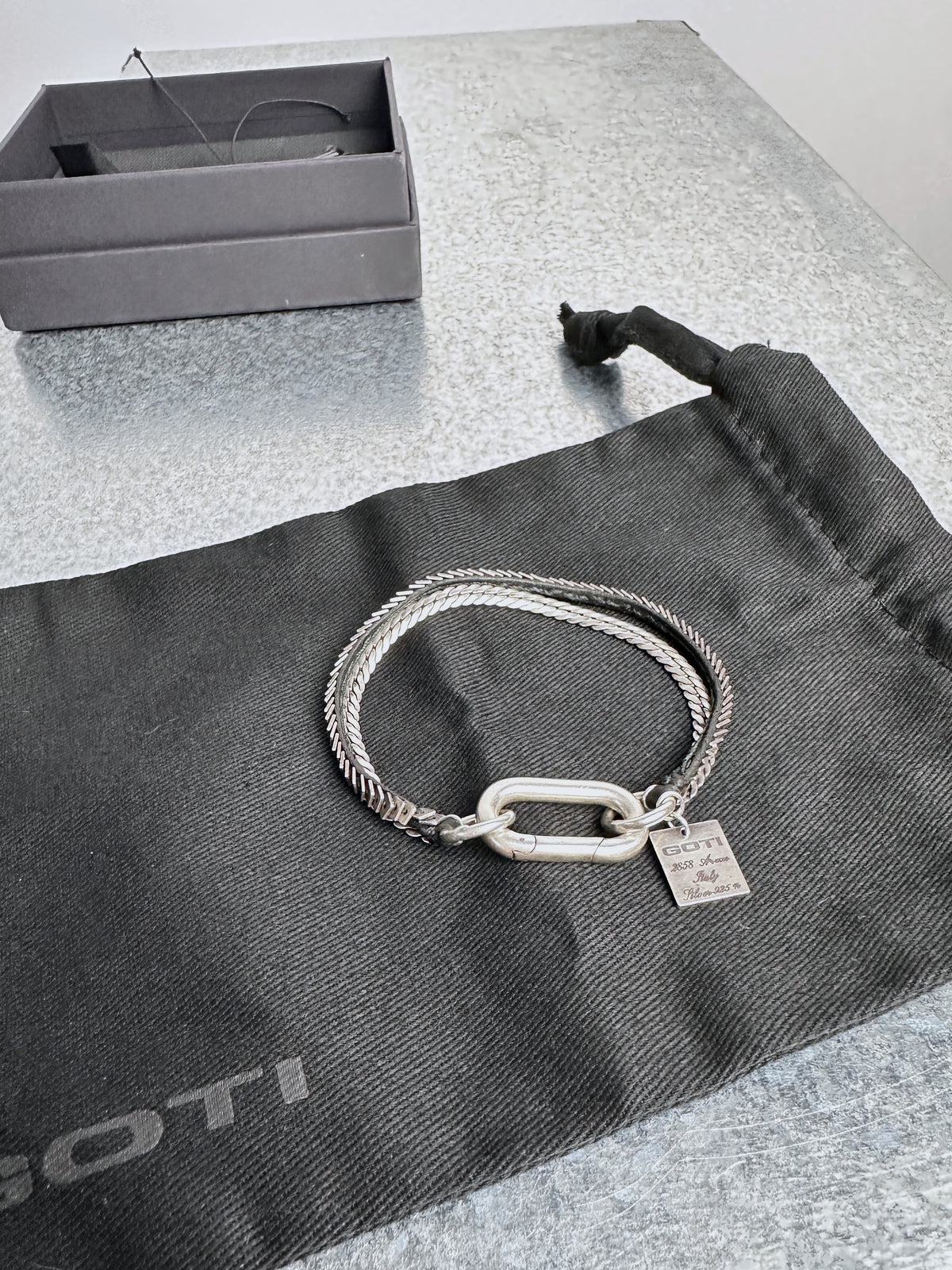 Coiled, carabiner clasp and tag