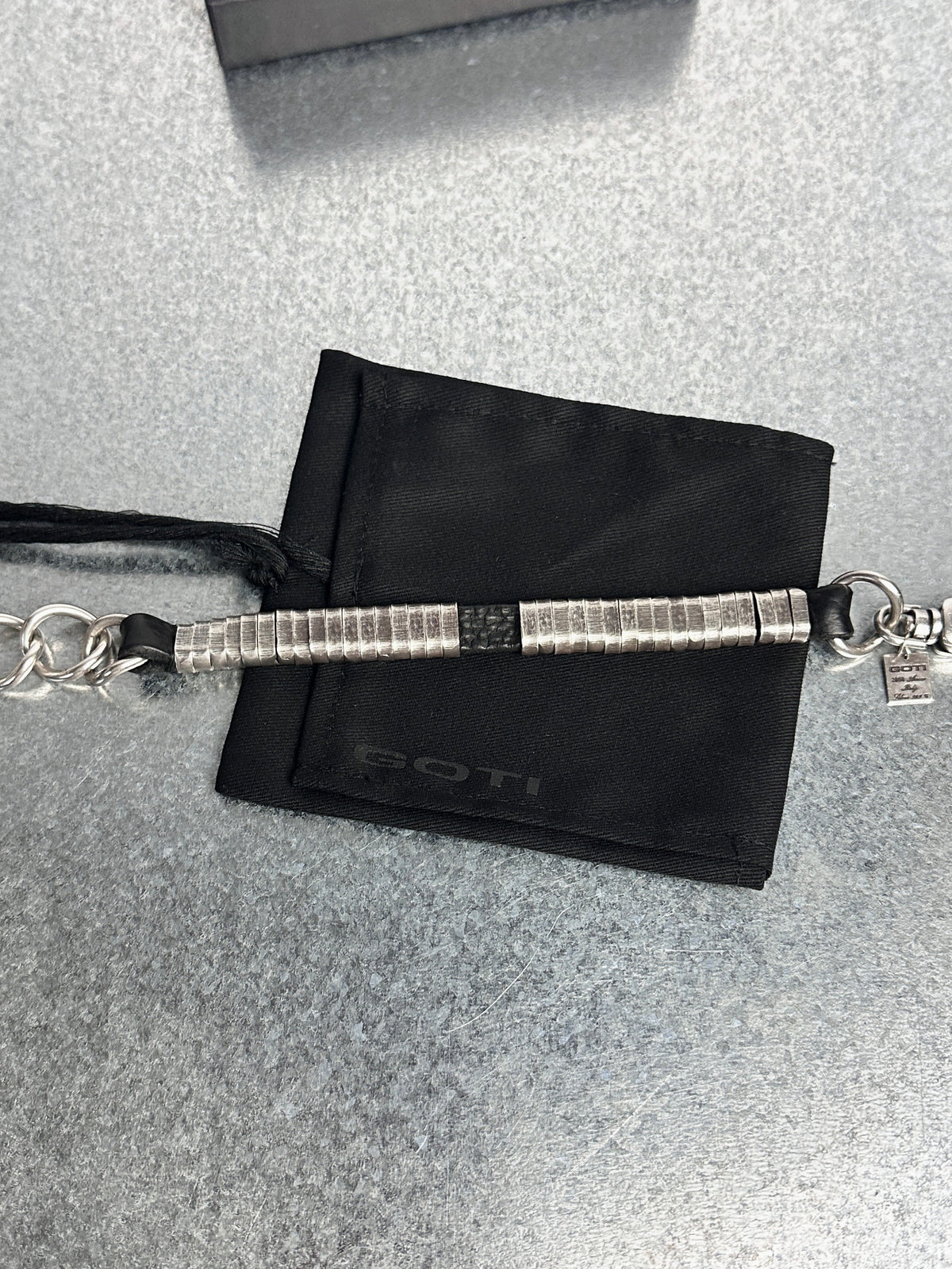 Stretched flat: coils, leather core and chain
