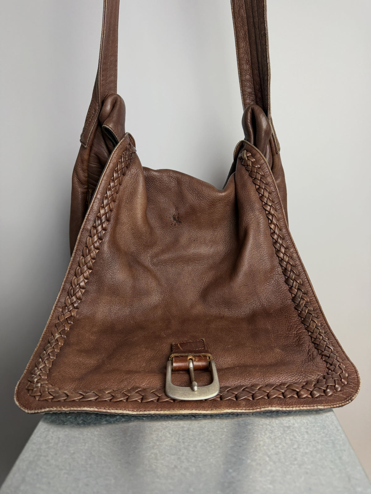 Flap open, braided trim around the edge