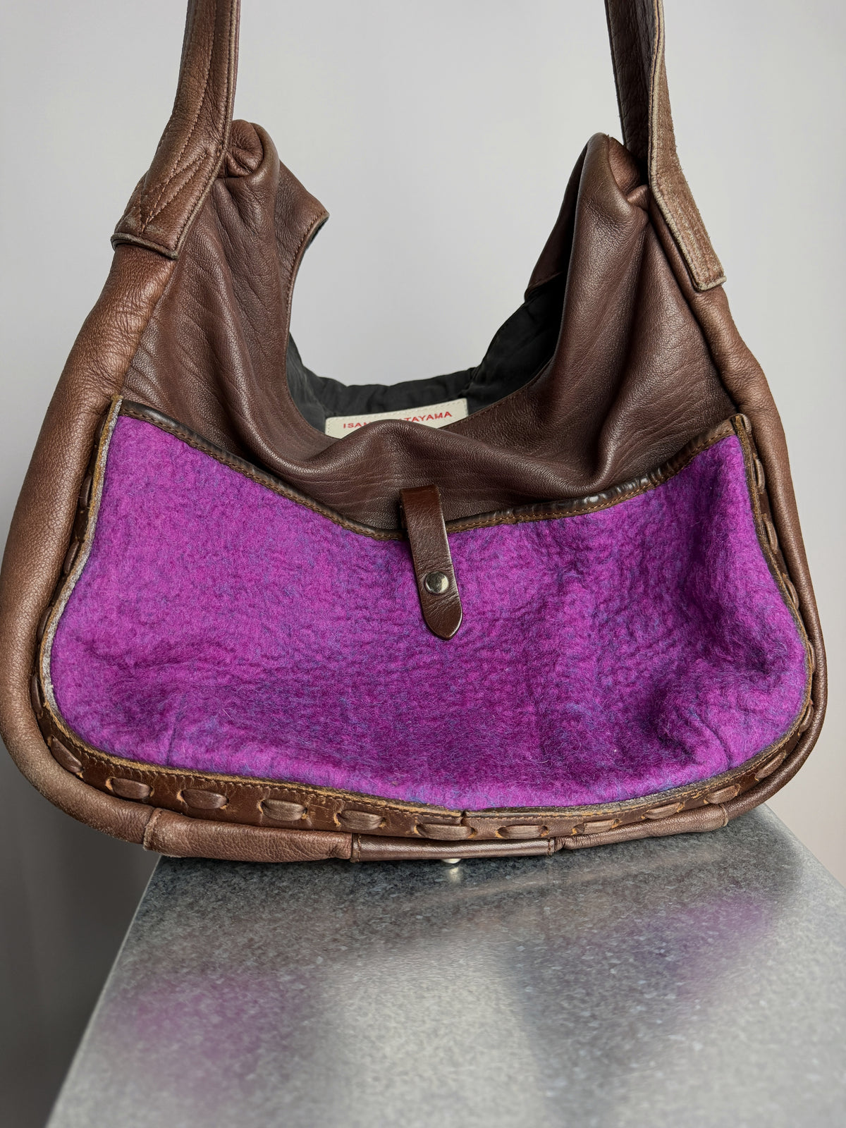 Pocket faced in magenta felted wool