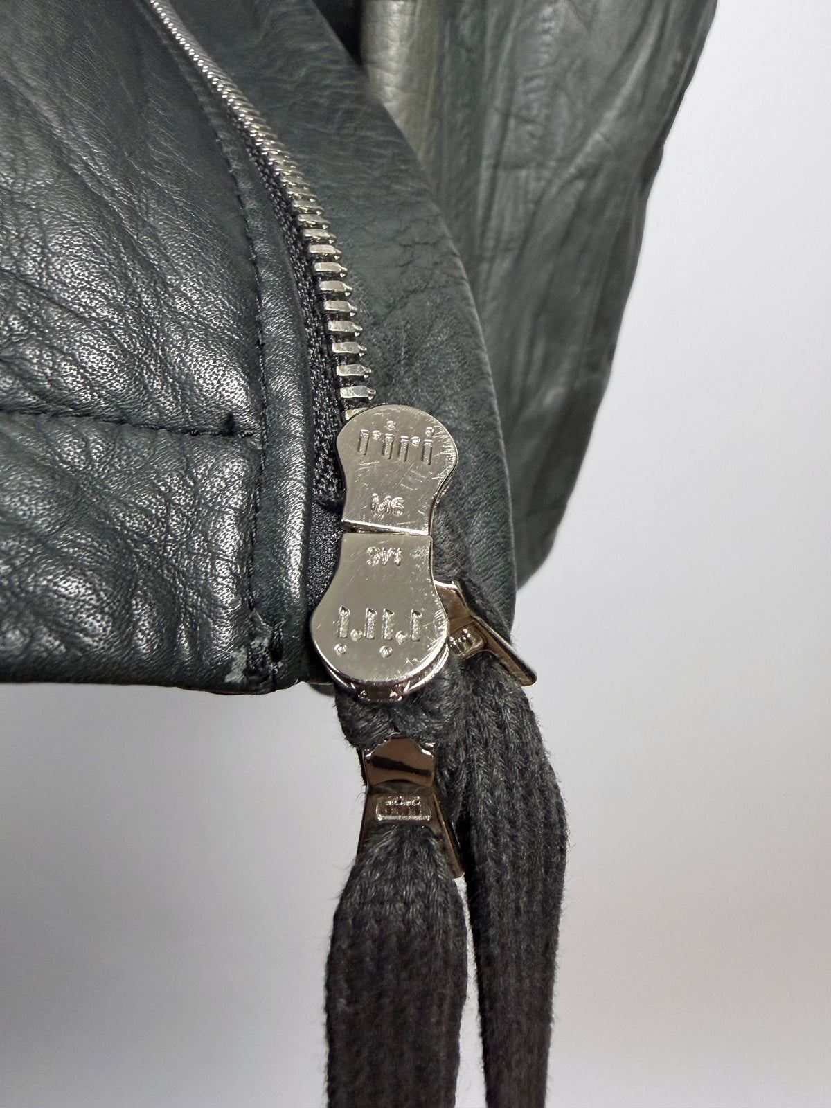 Zip sliders and silver-tipped cord pulls