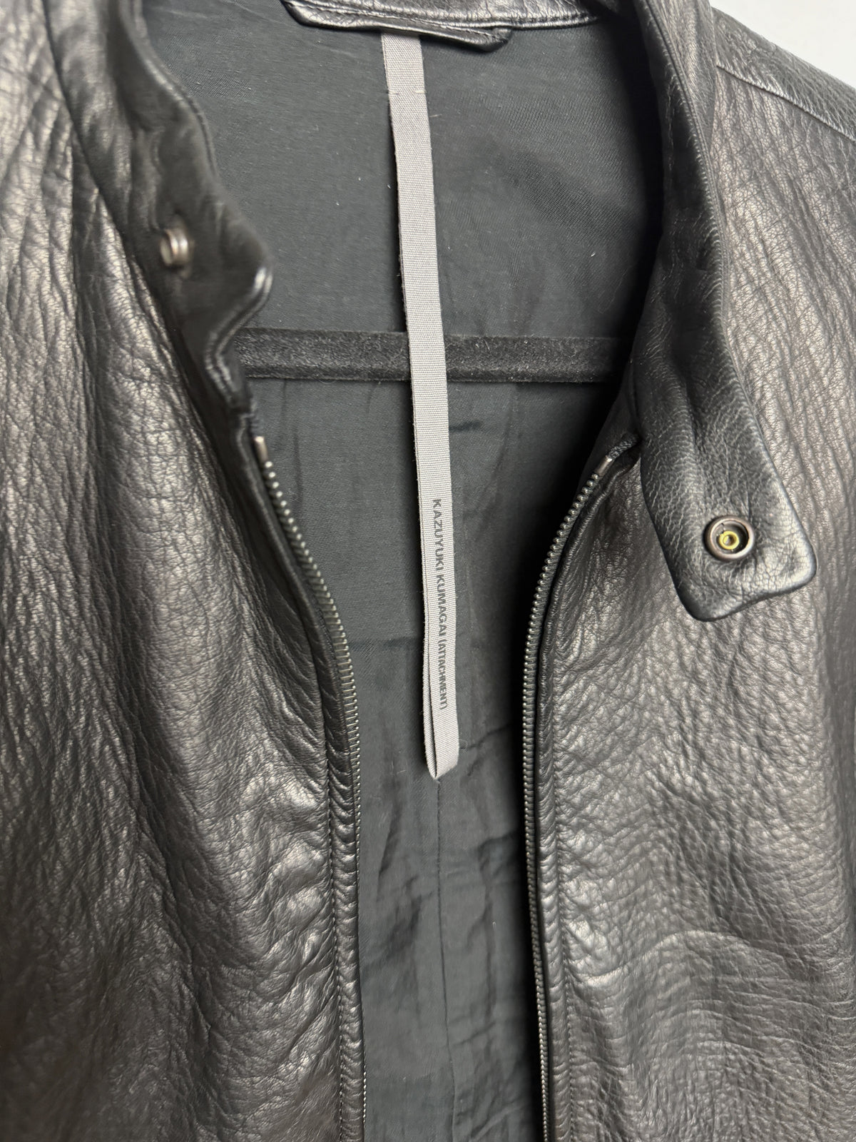 KAZUYUKI KUMAGAI (ATTACHMENT) label at the back neck