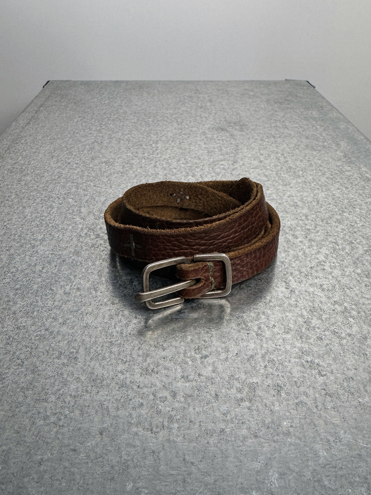 m.a+ cross studded bison leather belt, coiled