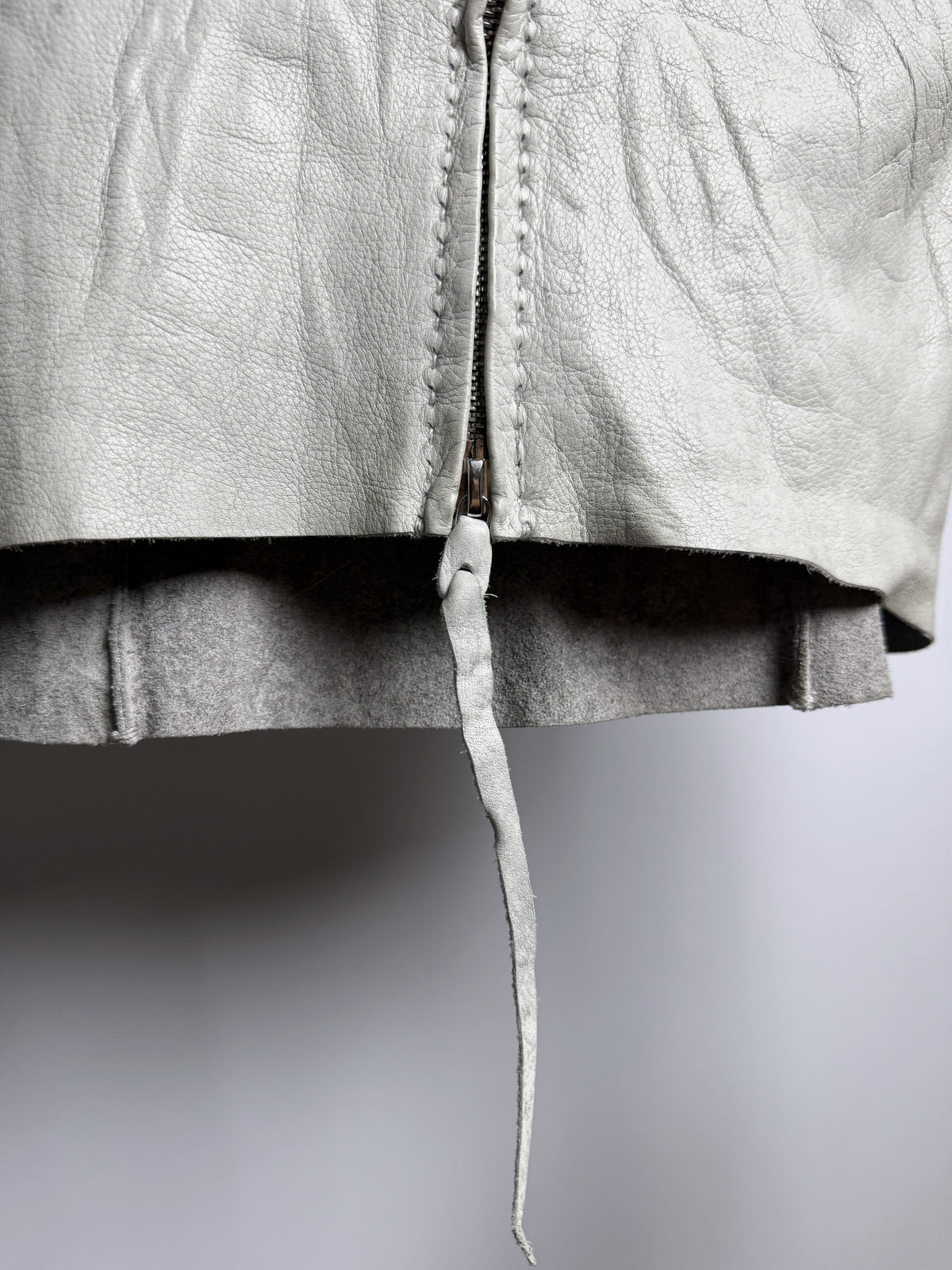 Hem and cut-leather zip pull