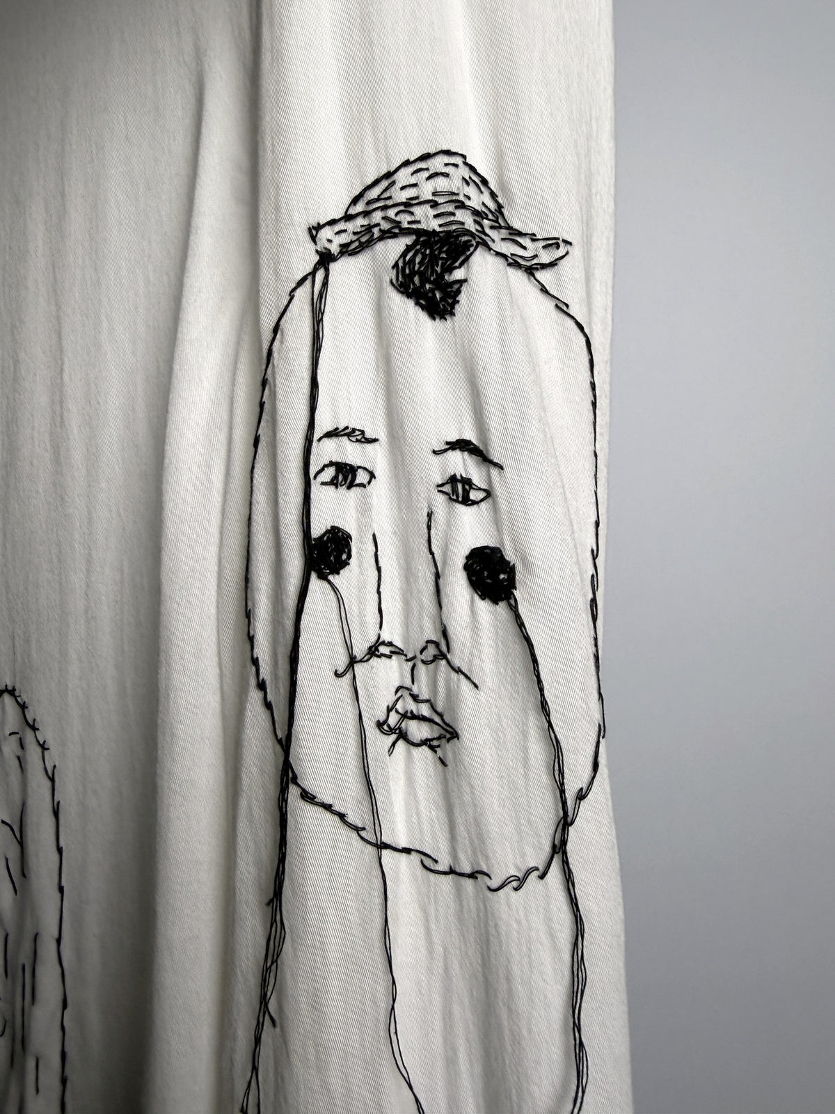 Face under a cap, on the sleeve