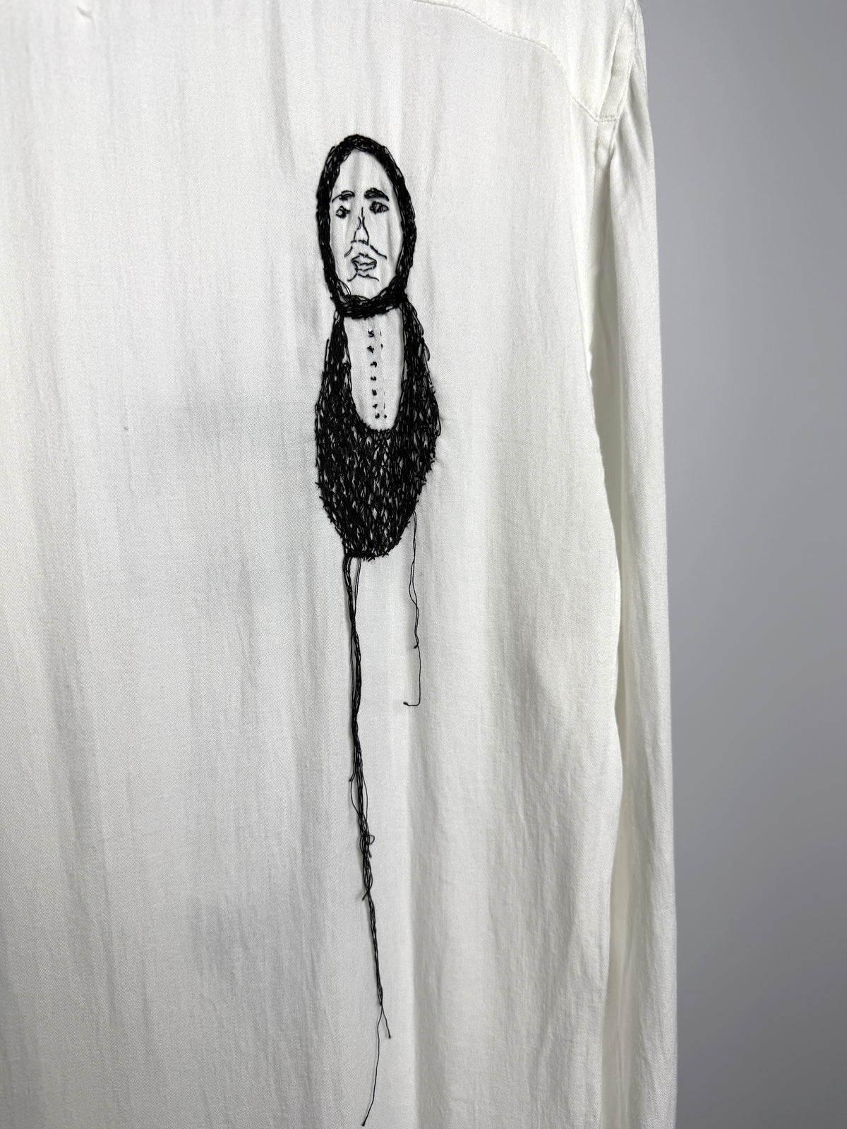 Figure hanging on a single thread, back