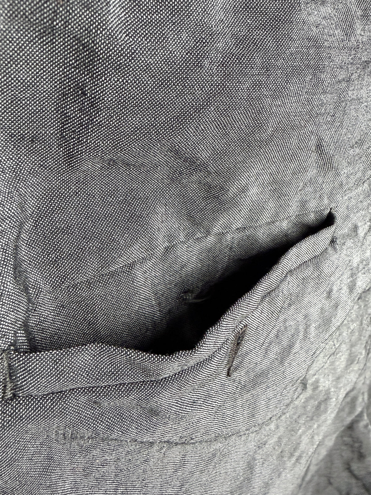 Darned repairs along the right pocket edge